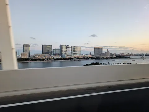 crossing back over the bay at golden hour, that silver disco ball perched on top is the Fuji TV building out on odaiba.