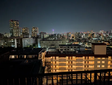 and here's the view that came with it. that purple-lit spire glowing out past the rooftops is the docomo tower, keeping an eye on us all night.