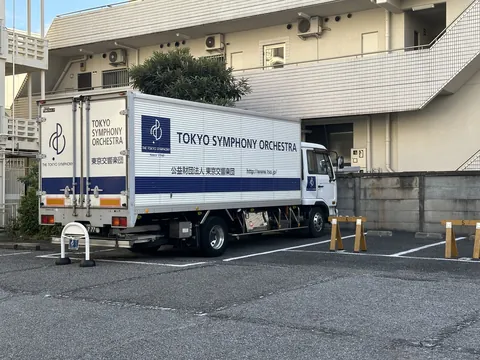 behold, my finest shinjuku capture: a Tokyo Symphony Orchestra box truck parked diagonally across an empty lot. zero regrets.