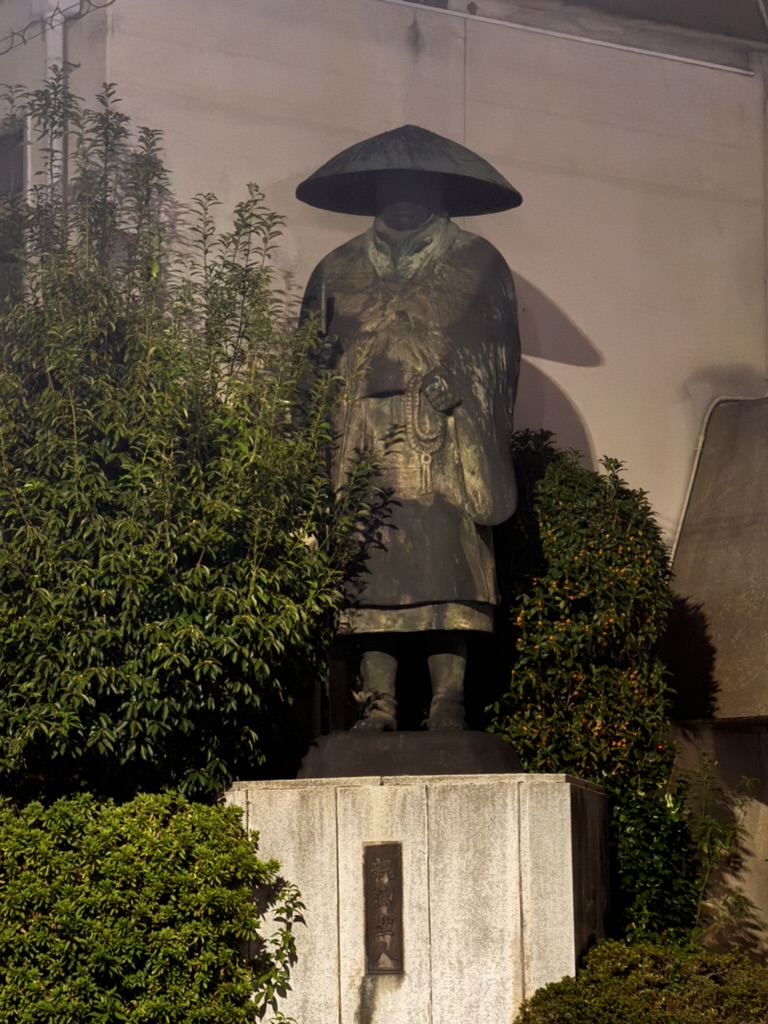 night shot of this eerie buddhist monk statue near higashi honganji temple. christina caught it looking extra mysterious in the shadows.