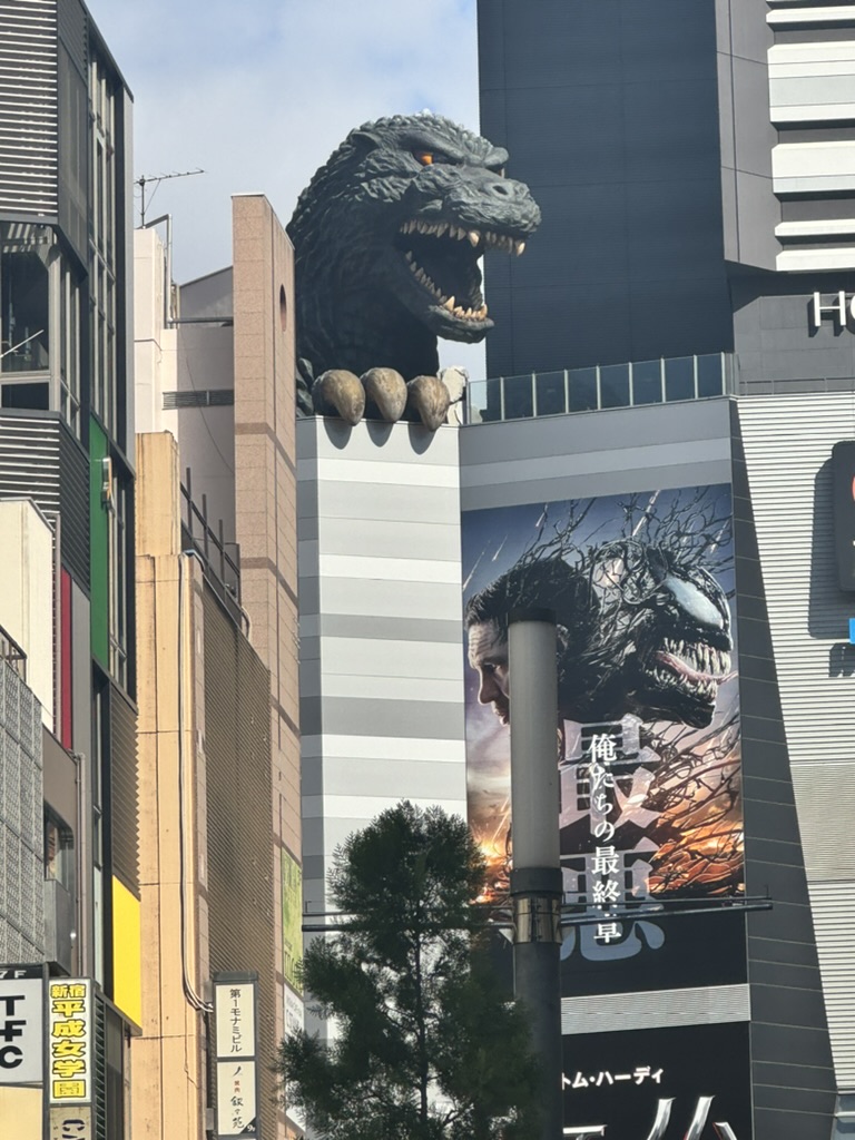 christina caught the iconic godzilla head looming over shinjuku's toho building, right next to a massive poster for the latest kaiju film