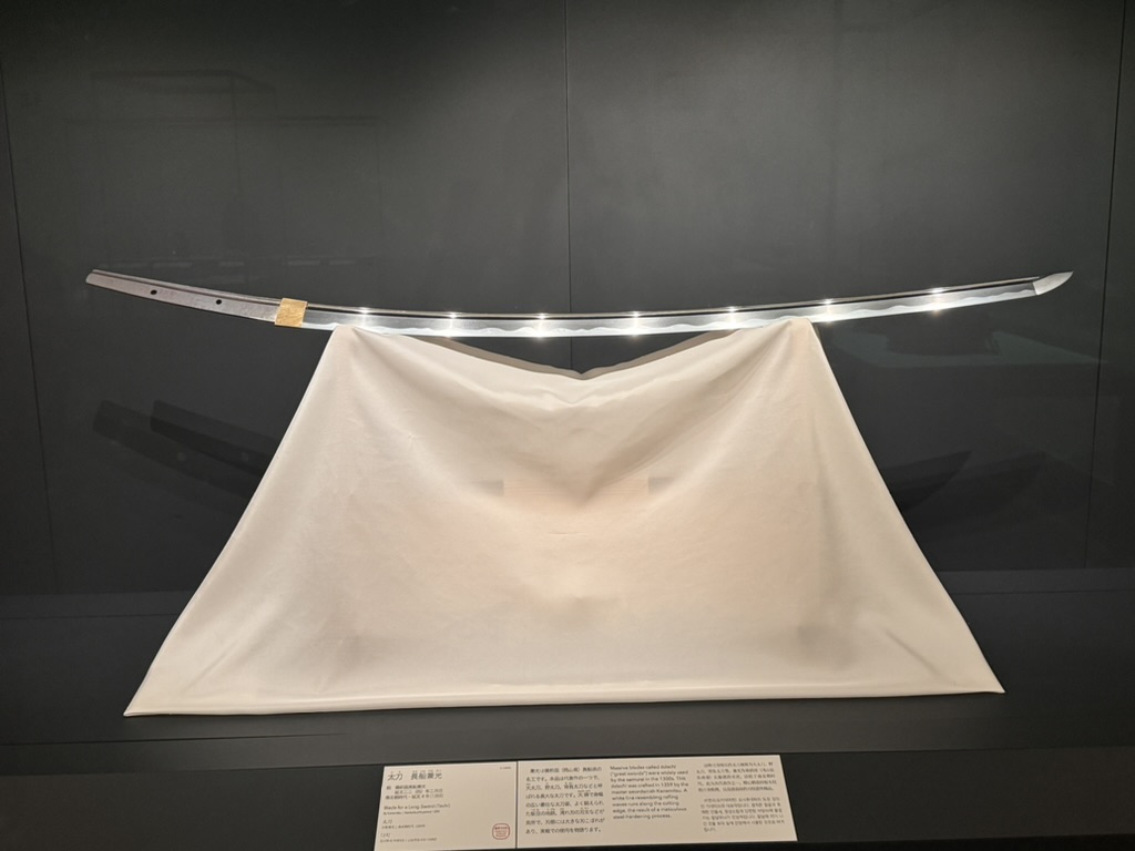 christina caught this elegant katana on display at the tokyo national museum, showing off its distinctive curved blade against white silk