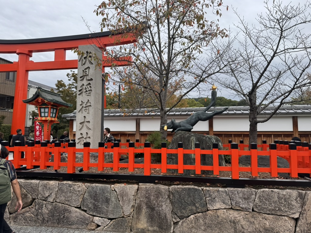 morning wandering through fushimi inari, where daniel spotted this cool fox statue along the famous orange torii gates. christina's getting pretty good with these shrine shots.