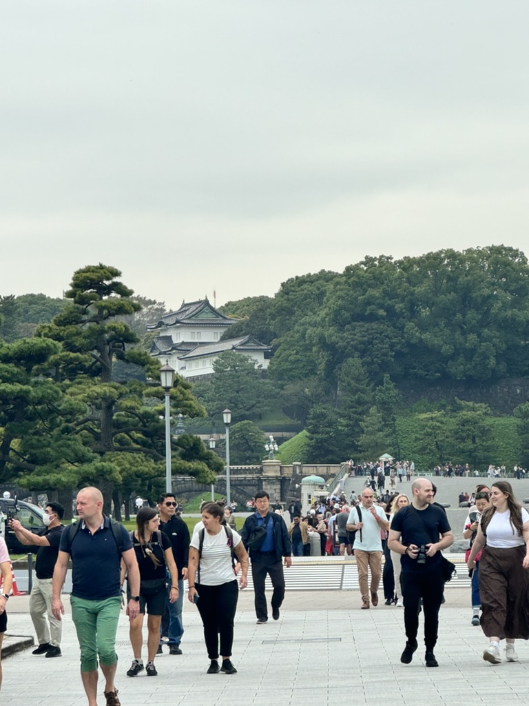 daniel and christina joining the crowd heading towards the IMPERIAL PALACE on a cloudy morning in chiyoda. typical tourist traffic for a wednesday.