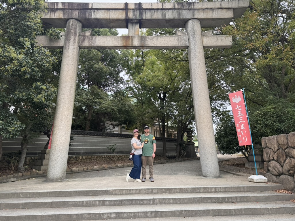 daniel and christina at the entrance to hokoku shrine, right next to osaka castle. early morning exploring before the crowds show up.