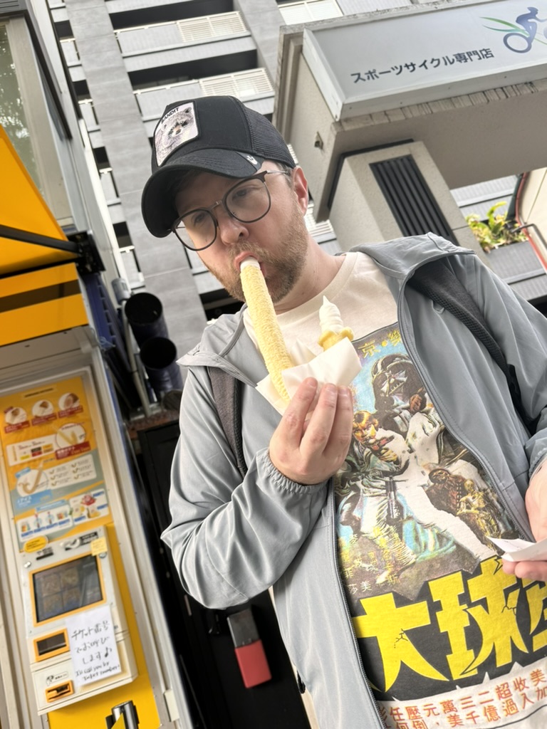 daniel found a long boi corn dog near pontocho alley in kyoto. his vintage kaiju movie t-shirt game is STRONG.