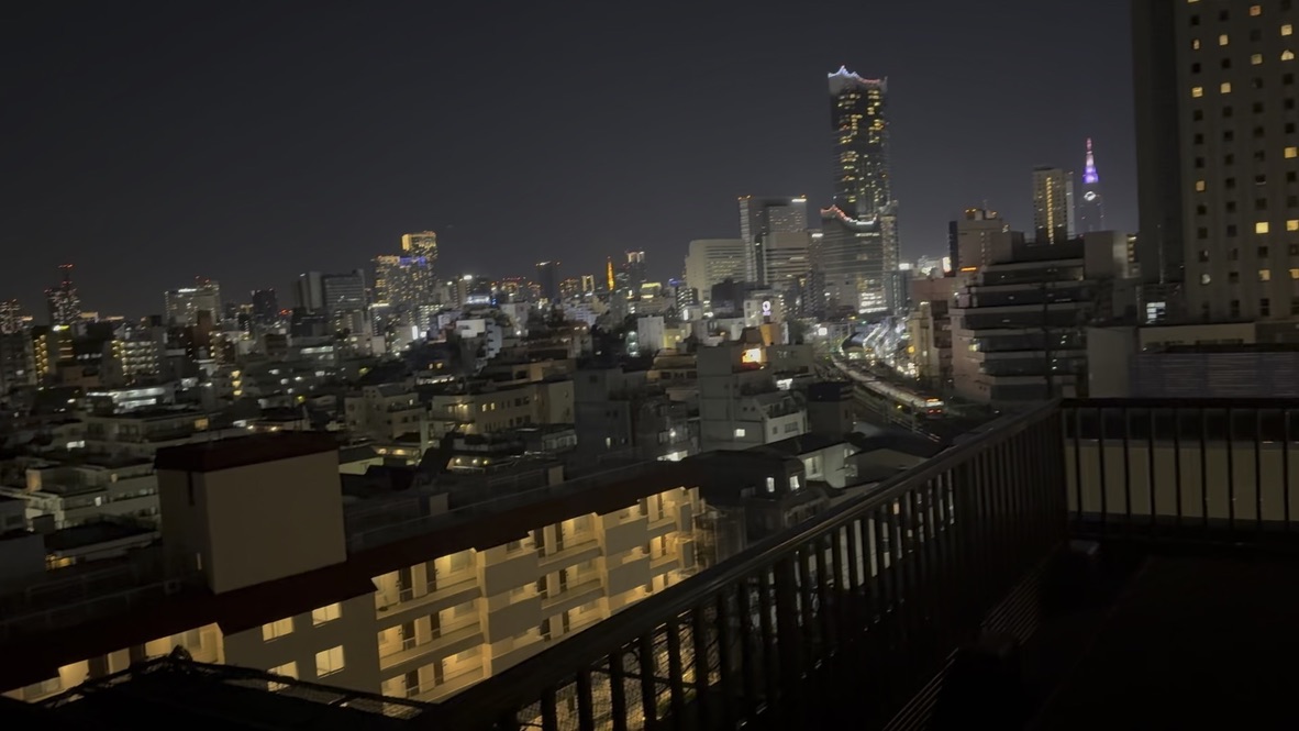 night view from our tokyo airbnb balcony with the MASSIVE landmark tower standing out against the skyline