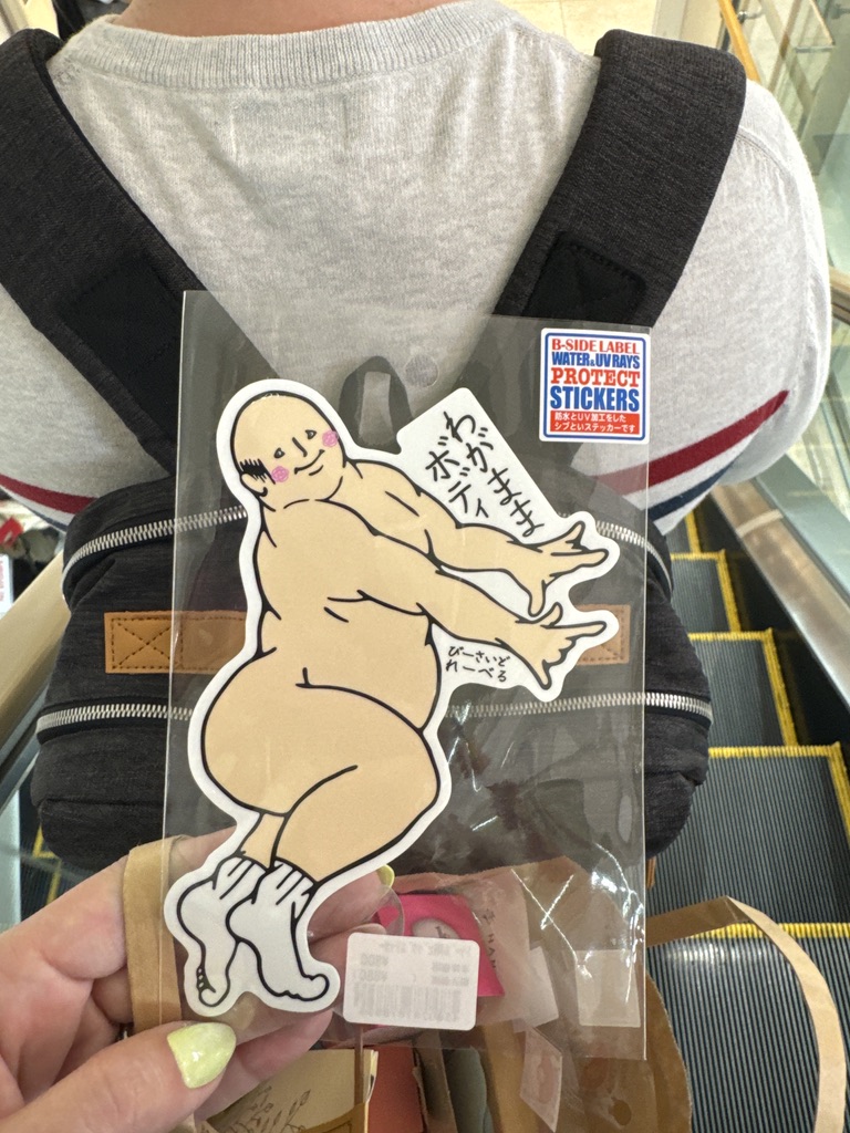 christina found this WILD sticker of the viral japanese mascot 'wata-ame ojisan' (cotton candy man) on an escalator in osaka