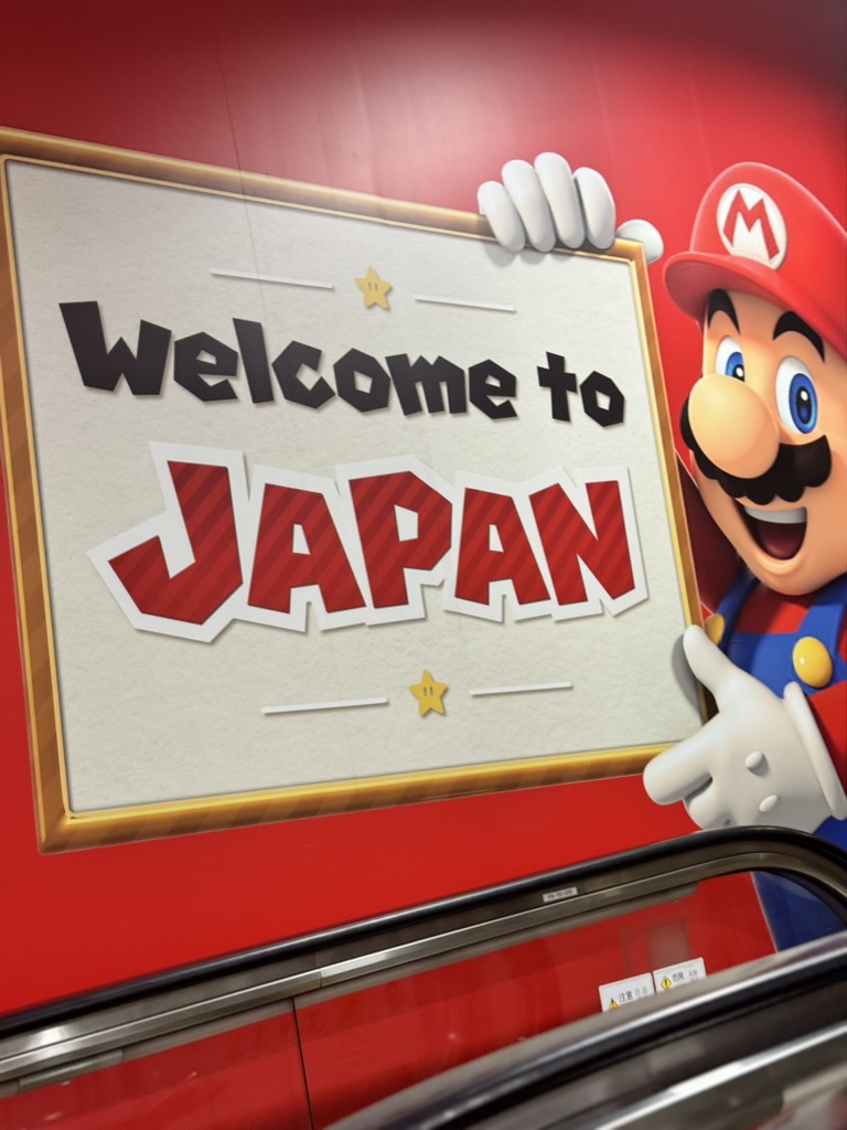 first glimpse of japan at narita airport - nintendo welcoming us with mario at terminal 1. dan and christina's 14-hour flight just got a bit more fun.