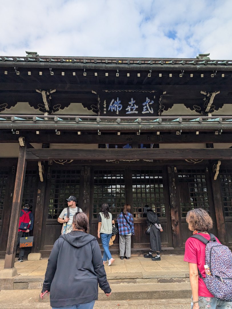 waiting in line at gotokuji temple in setagaya, where chuck managed to snap this pic of the entrance with its MASSIVE wooden beams and traditional kanji signage