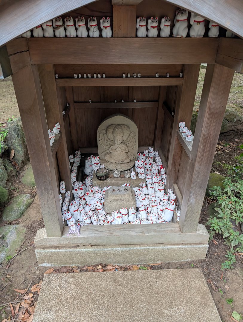 chuck found this AMAZING shrine packed with maneki-neko (lucky cats) surrounding a buddha statue in setagaya