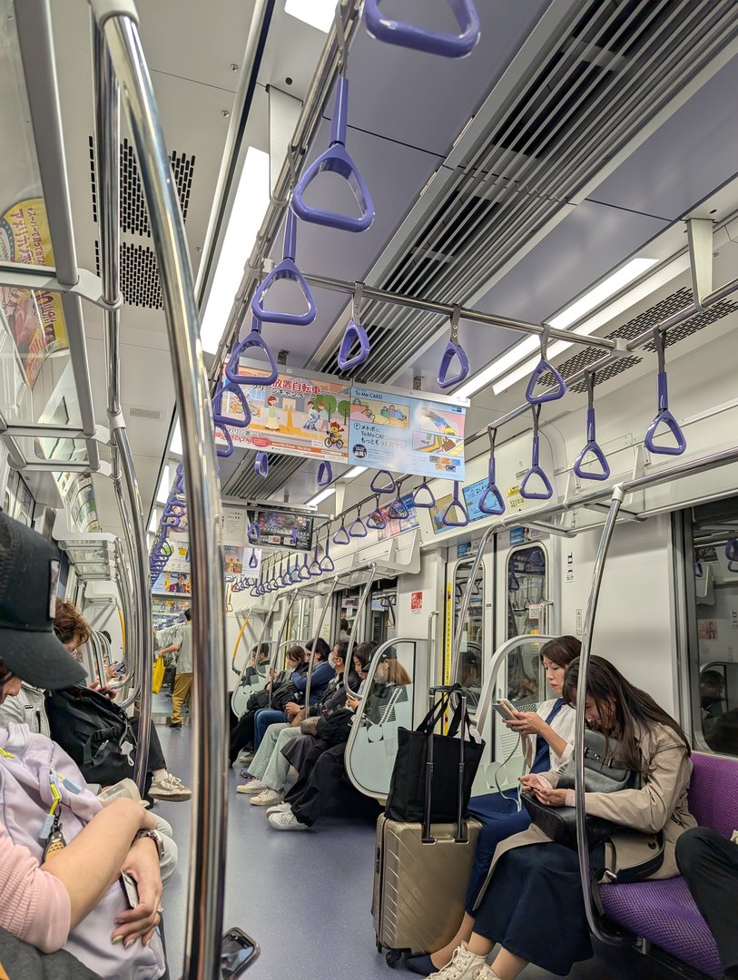 riding the tokyo metro during rush hour - everyone's glued to their phones in PEAK japanese commuter style