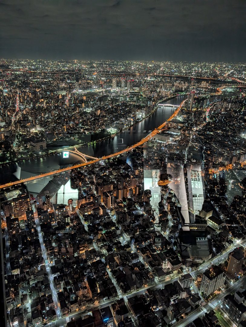 night view from the tokyo SKYTREE observation deck - chuck caught the sumida river looking like a glowing snake cutting through the city