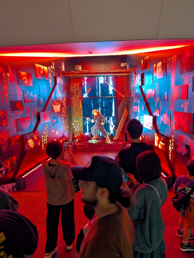 daniel and christina checking out this WILD anime installation at the tokyo skytree. the neon-lit room was giving major cyberpunk vibes