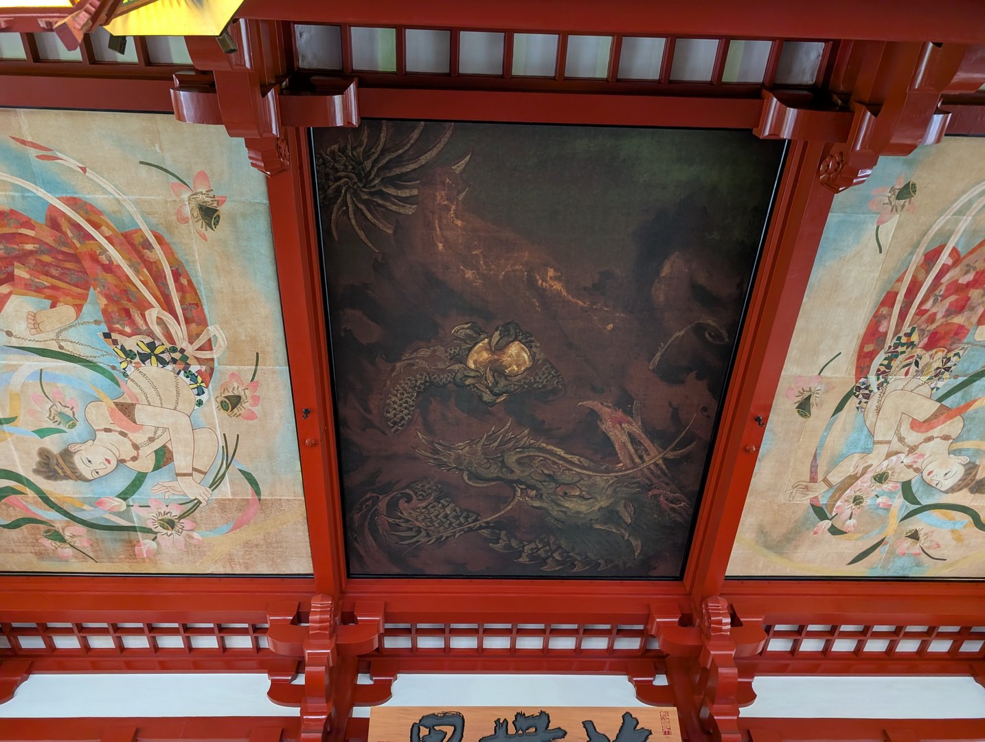 looking up at the INCREDIBLE ceiling art at sensoji temple - chuck managed to get this shot of the dragon painting surrounded by flying tennin figures