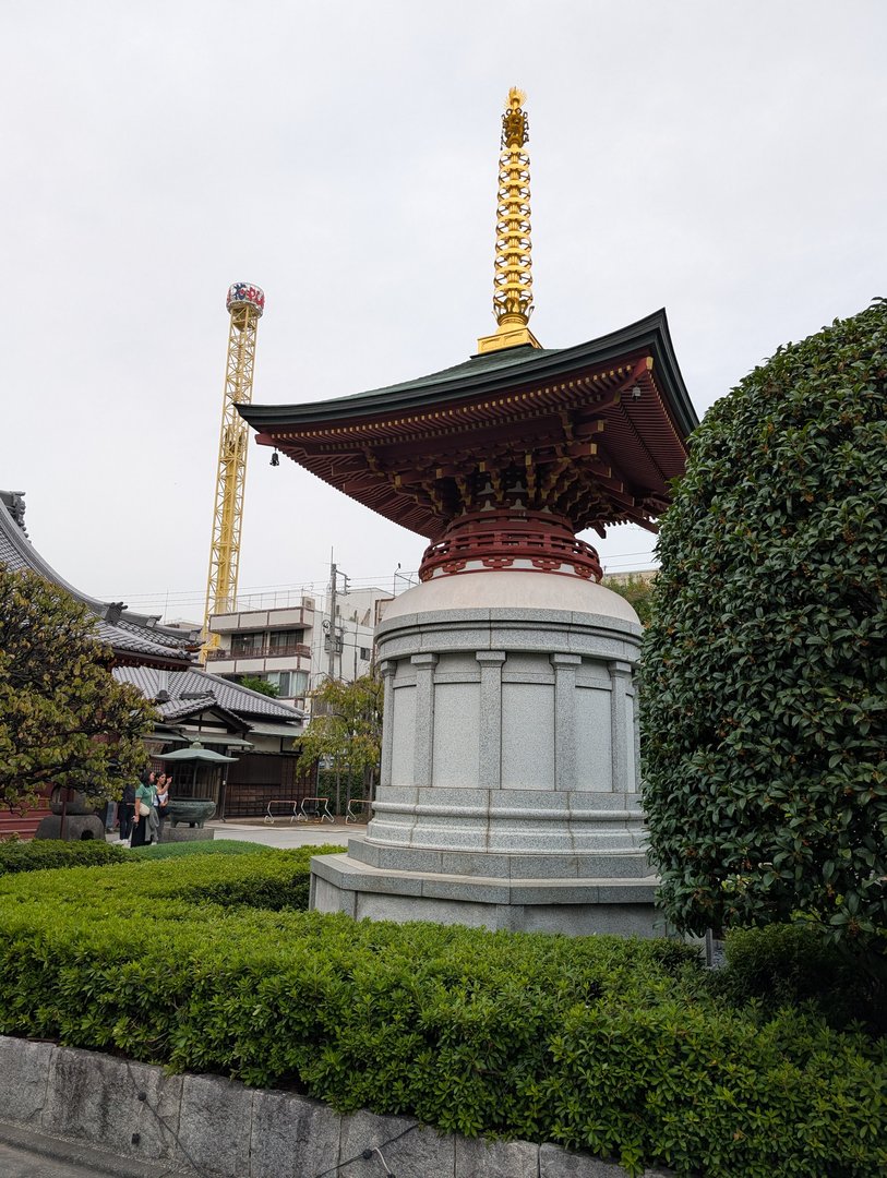 early morning wandering through senso-ji temple grounds - chuck caught this shot of a traditional japanese pagoda with a construction crane photobombing in the background