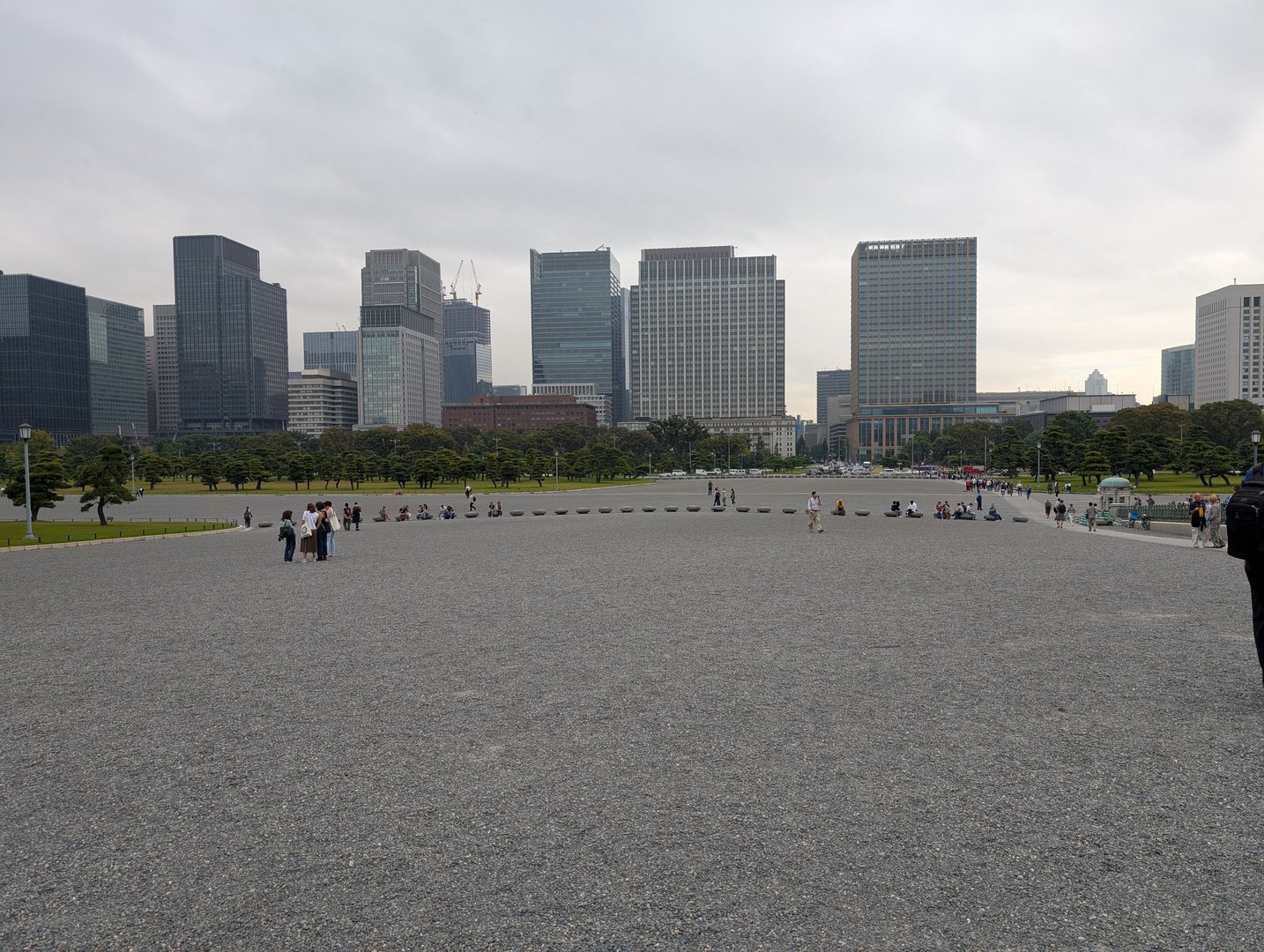 the contrast between old and new tokyo hits different from the imperial palace grounds - chuck caught this view of the marunouchi skyline while we explored the outer gardens