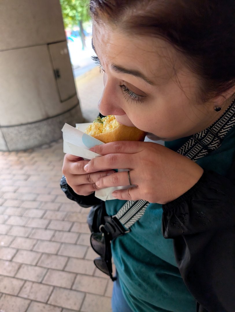 ashley diving into what looks like a melonpan near ginza - these sweet japanese bread rolls are NO JOKE good