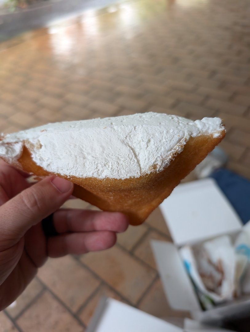 chuck's first encounter with a PROPER beignet at cafe du monde in chūō - way more powdered sugar than the knockoffs back home