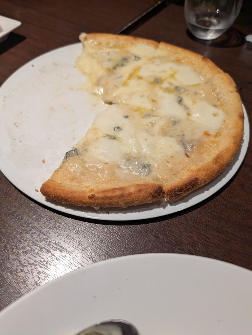 late night four-cheese pizza at this random spot in osaka - sometimes you just need a break from japanese food