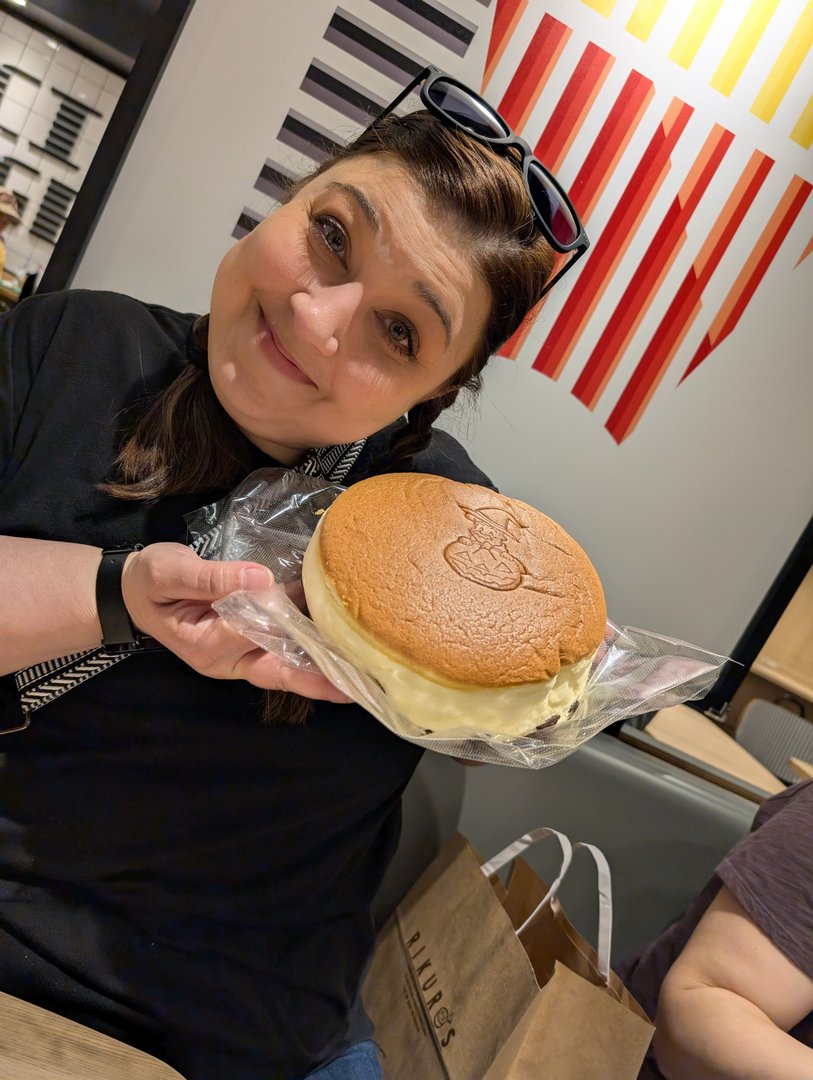 ashley showing off her first-ever japanese cheesecake from rikuro ojisan in osaka's namba district