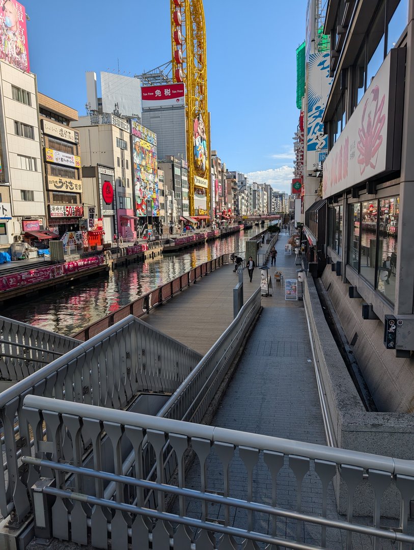 morning light hits the dotonbori canal just right - chuck caught this quiet moment before the crowds descended on osaka's most FAMOUS food street