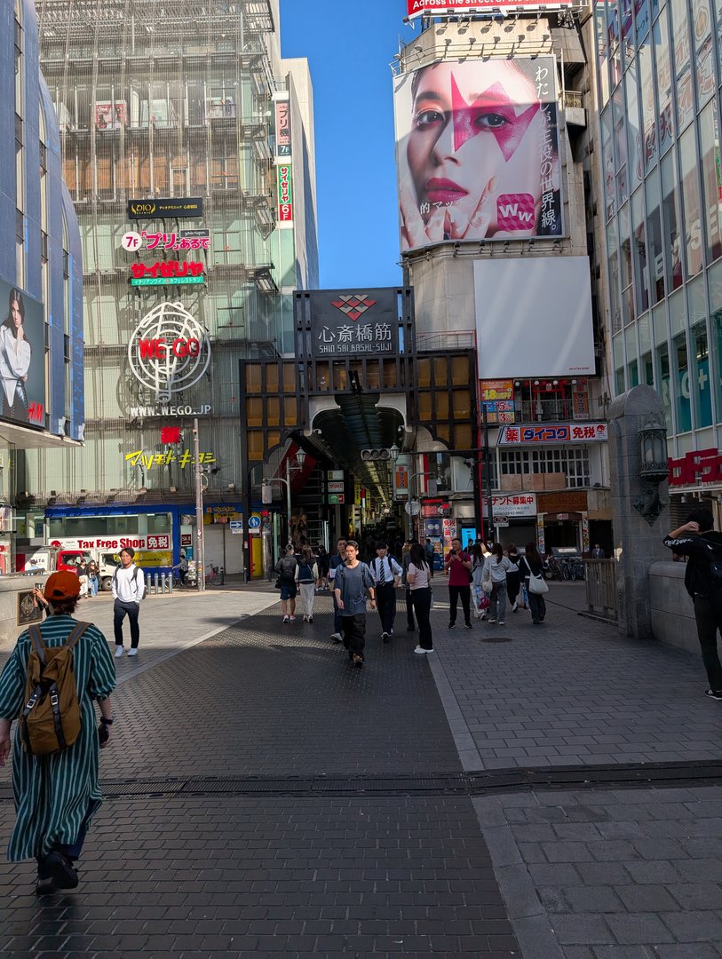 morning wandering through osaka's shinsaibashi-suji, where chuck caught this shot of the iconic shopping arcade entrance with that MASSIVE david bowie-inspired billboard looming above