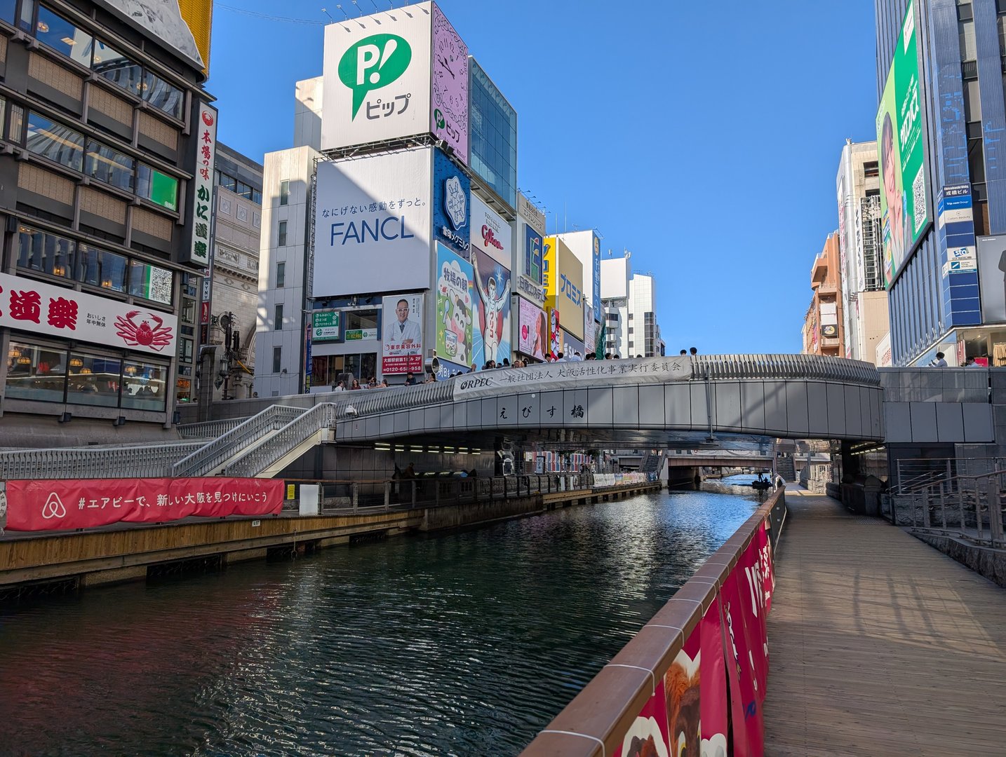 morning walk along the dotonbori canal - chuck caught this iconic osaka view near the ebisu bridge where all the massive billboards meet the water