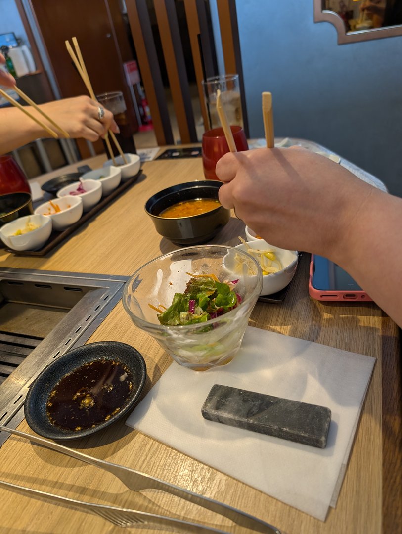 lunch break at a yakiniku spot in dotonbori - chuck and ashley trying to master those chopsticks with the dipping sauces