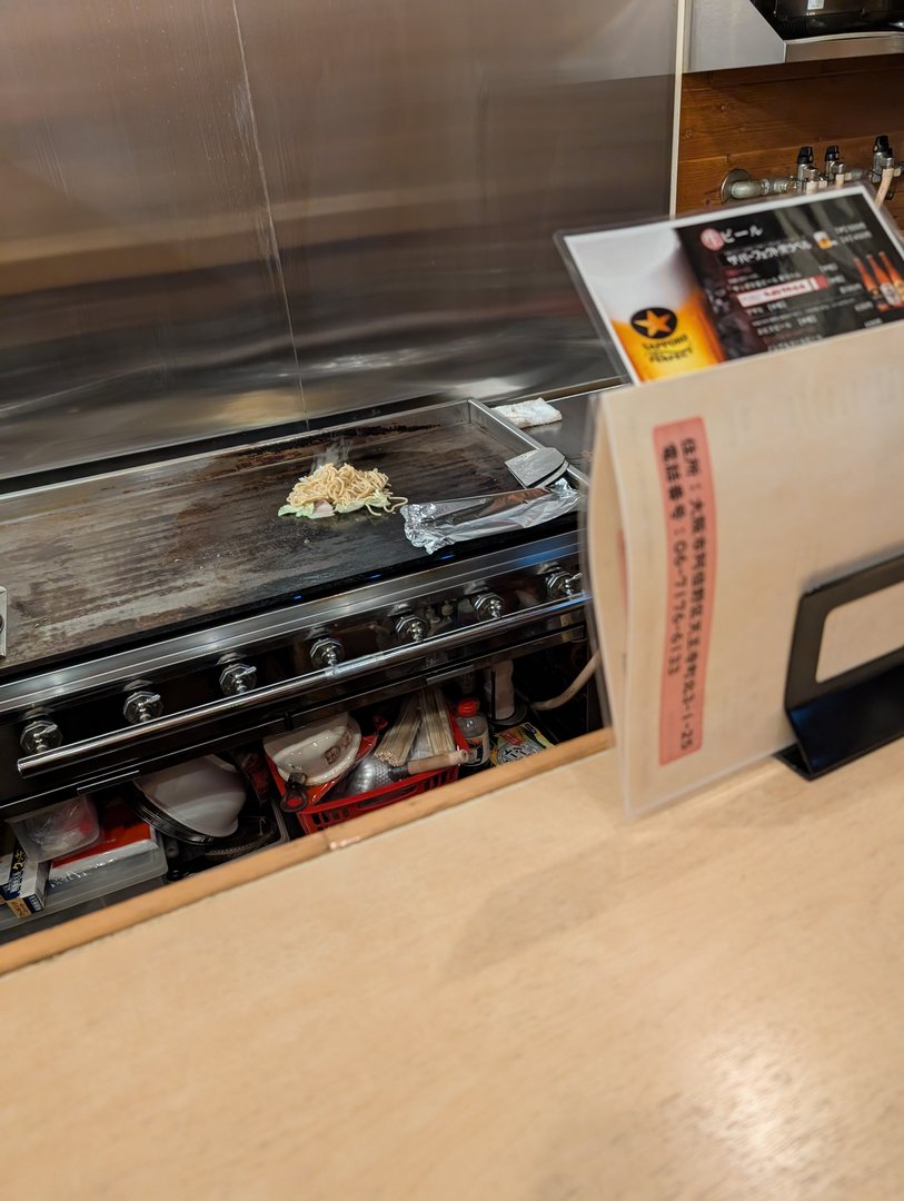 watching our yakisoba come to life on the teppanyaki grill at this tiny spot near tennoji station. chuck's first time seeing japanese street food made right in front of us.