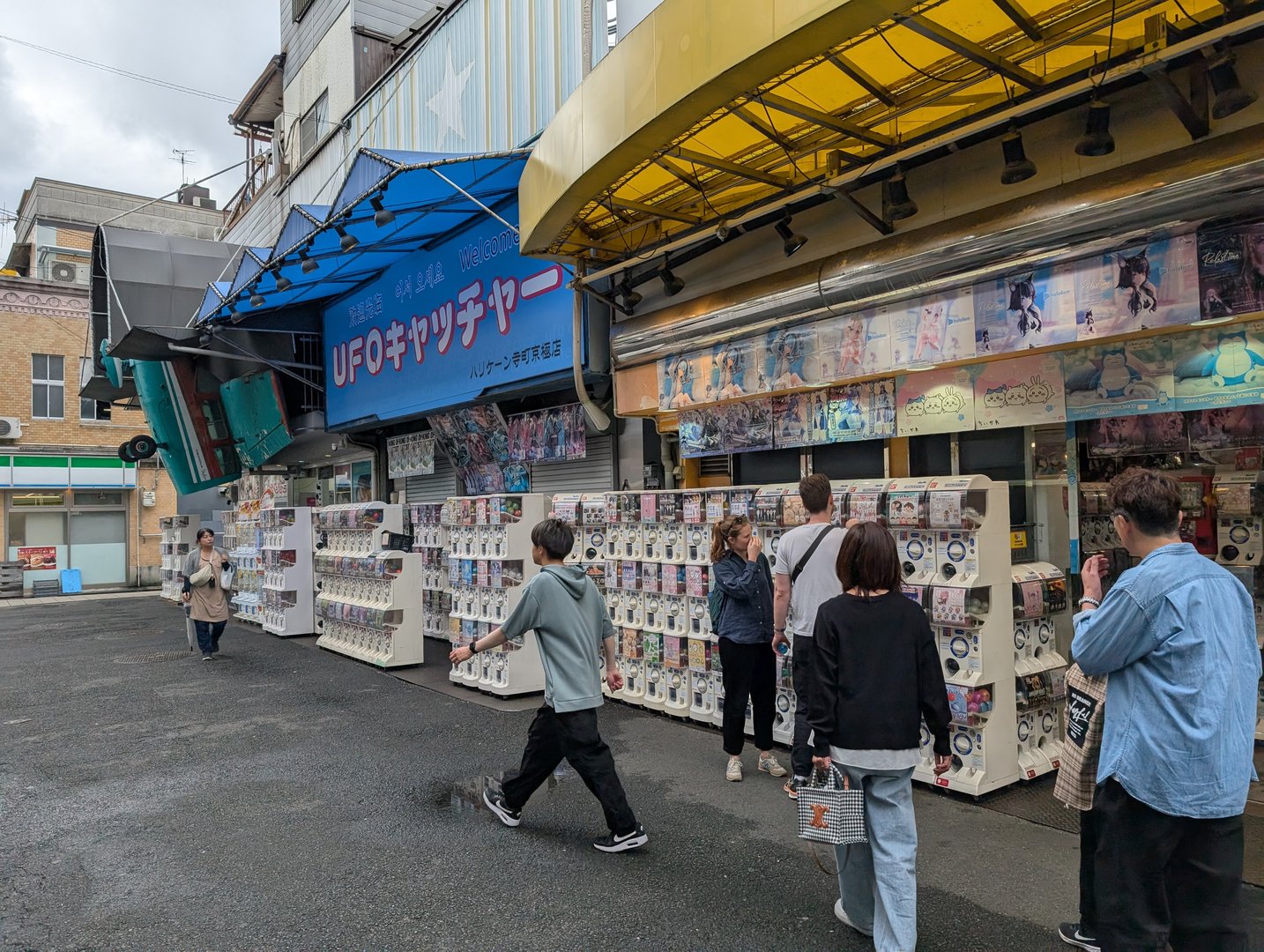 daniel and christina checking out the MASSIVE wall of gacha machines near nishiki market. these things are everywhere in kyoto but this spot was next level.