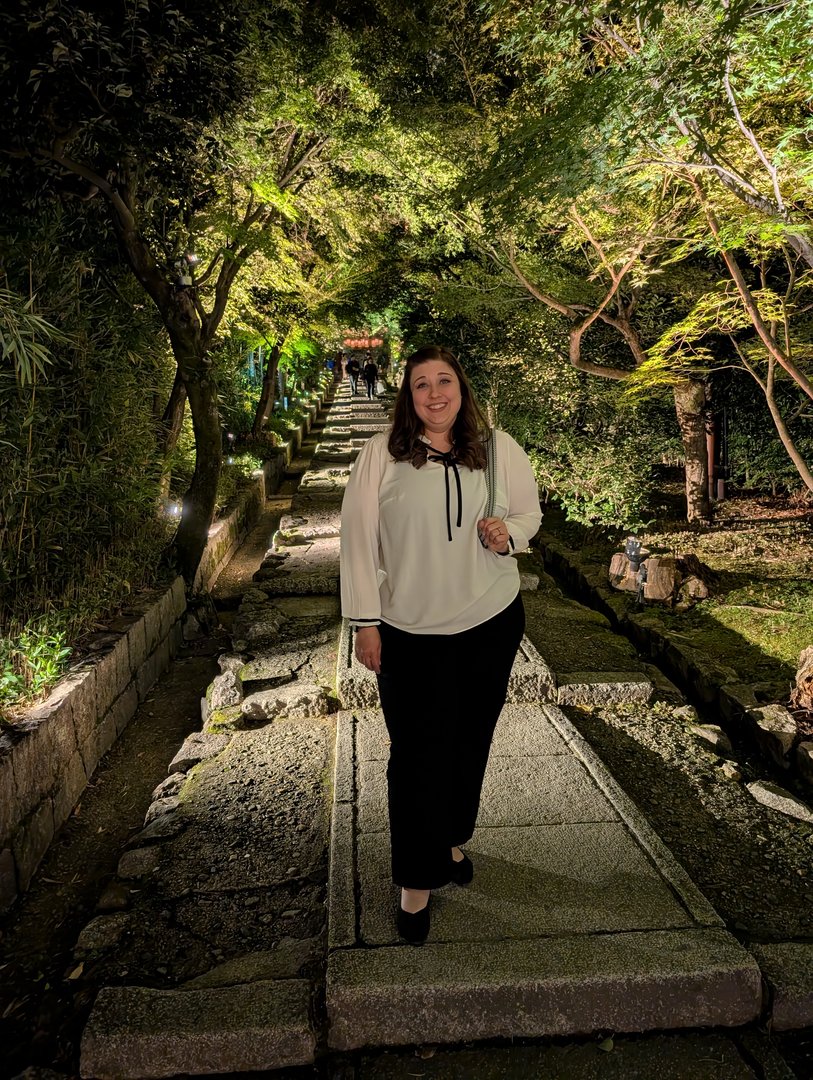 ashley on the illuminated path at kodaiji temple during their evening light-up event. the maple trees are just starting to turn for fall.