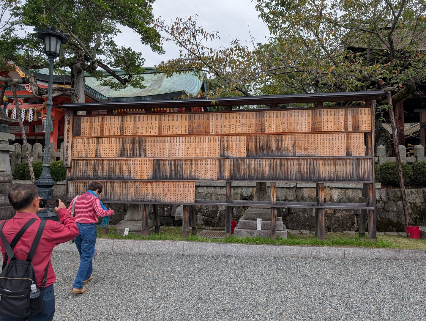 checking out the massive ema board at fushimi inari shrine - these wooden plaques have names of THOUSANDS of donors who helped maintain the shrine over the years