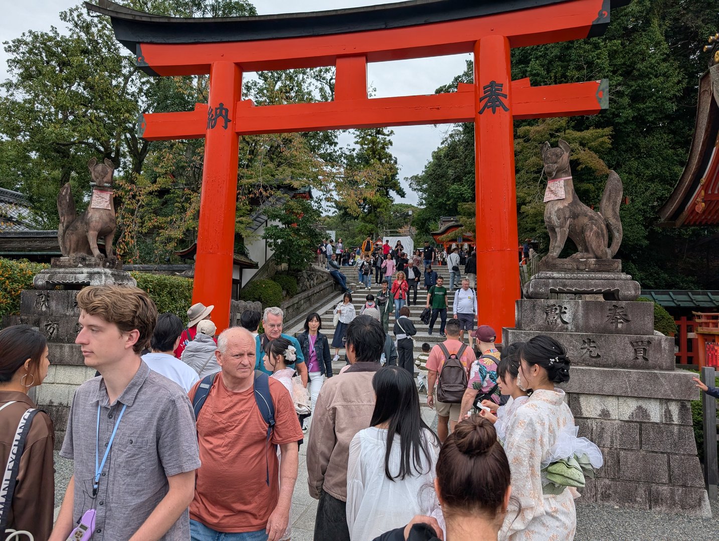 daniel and christina joining the crowd at the base of the ICONIC steps leading to fushimi inari shrine. tourist season is no joke here.