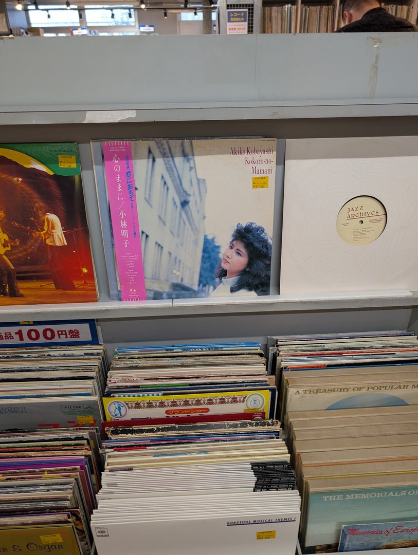 digging through stacks of vintage japanese vinyl at a record shop in tokyo. akiko kobayashi's 1984 album 'kokorone mamani' caught my eye with that CLASSIC city pop aesthetic.