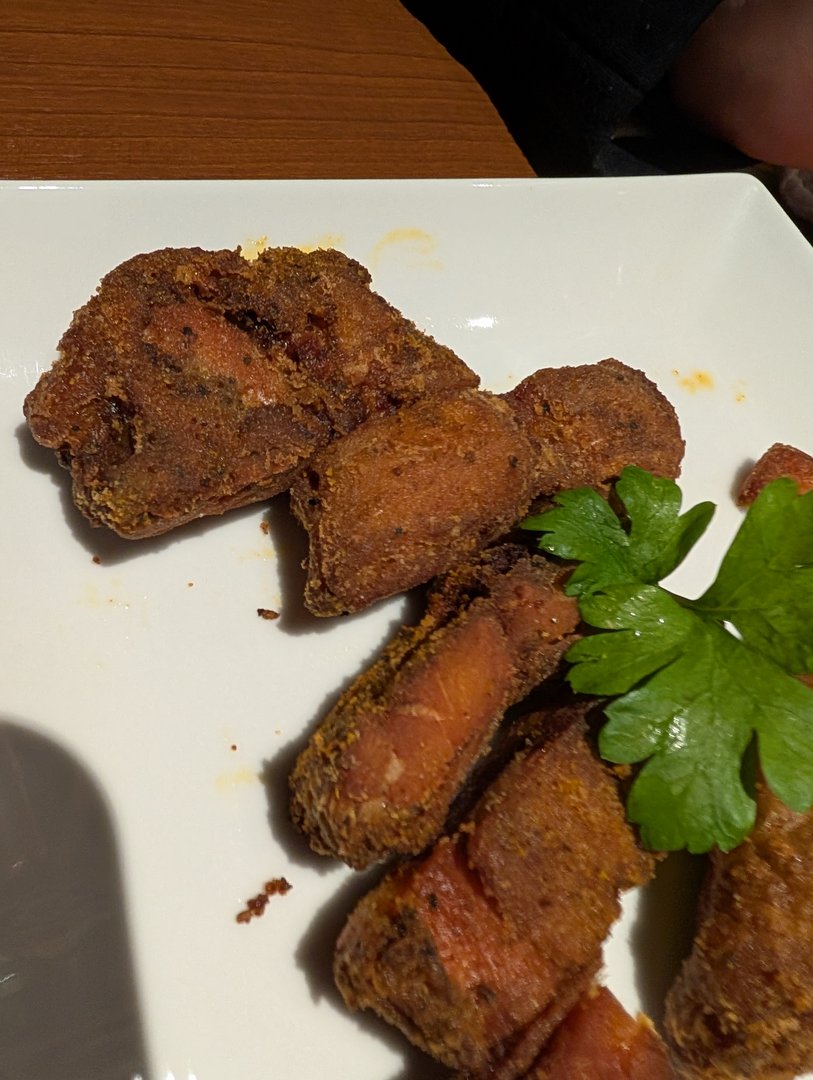 chuck and ashley trying deep-fried salmon at a spot near suidobashi station - way better than we expected for hotel restaurant food