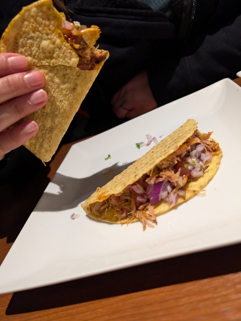 late night tacos at chidori, this tiny fusion spot in osaka that puts a japanese spin on mexican food. ashley's pink nails approve of the pulled pork with red onions.