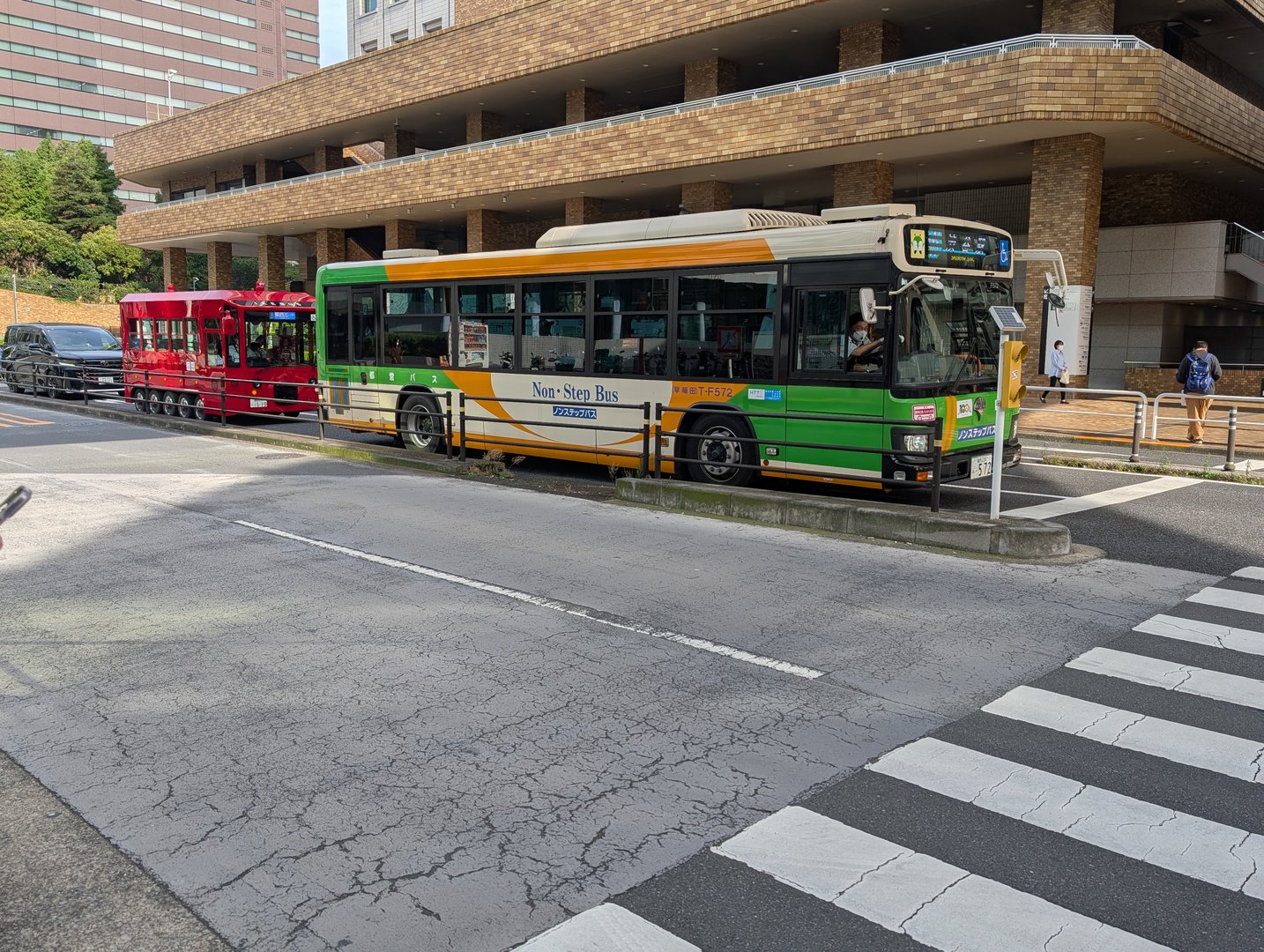 spotted this quirky combo near sunshine city - a regular tokyo bus lined up with what looks like a tourist trolley in toshima