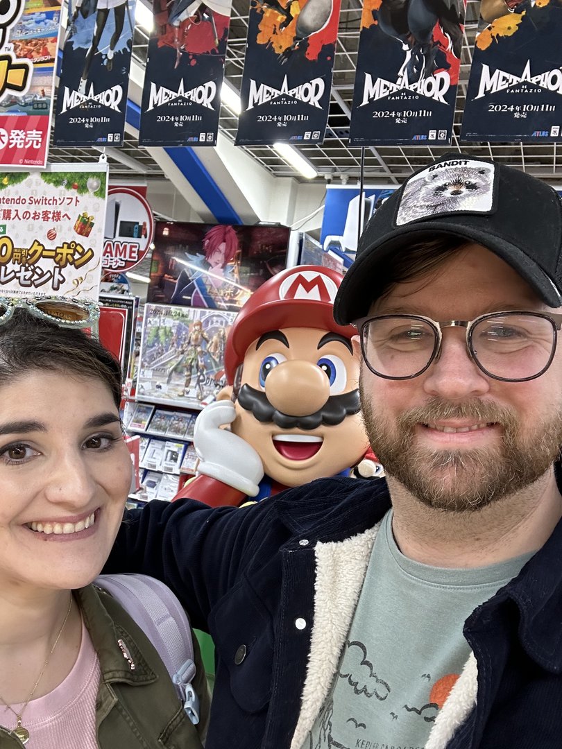 christina and dan found their way to a game store in shinjuku, with mario making an unexpected photobomb under some MEGADOR promo banners