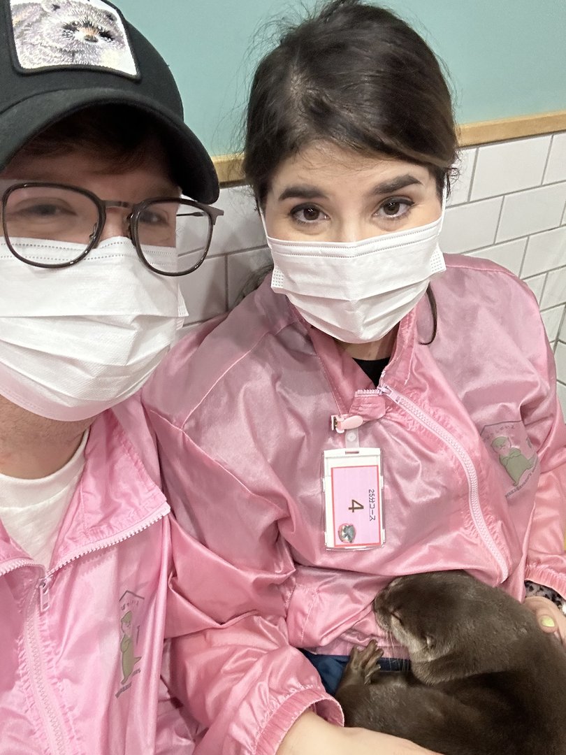 dan and christina rocking matching pink jumpsuits at the LEGENDARY harajuku otter cafe - way more chill than the owl cafes