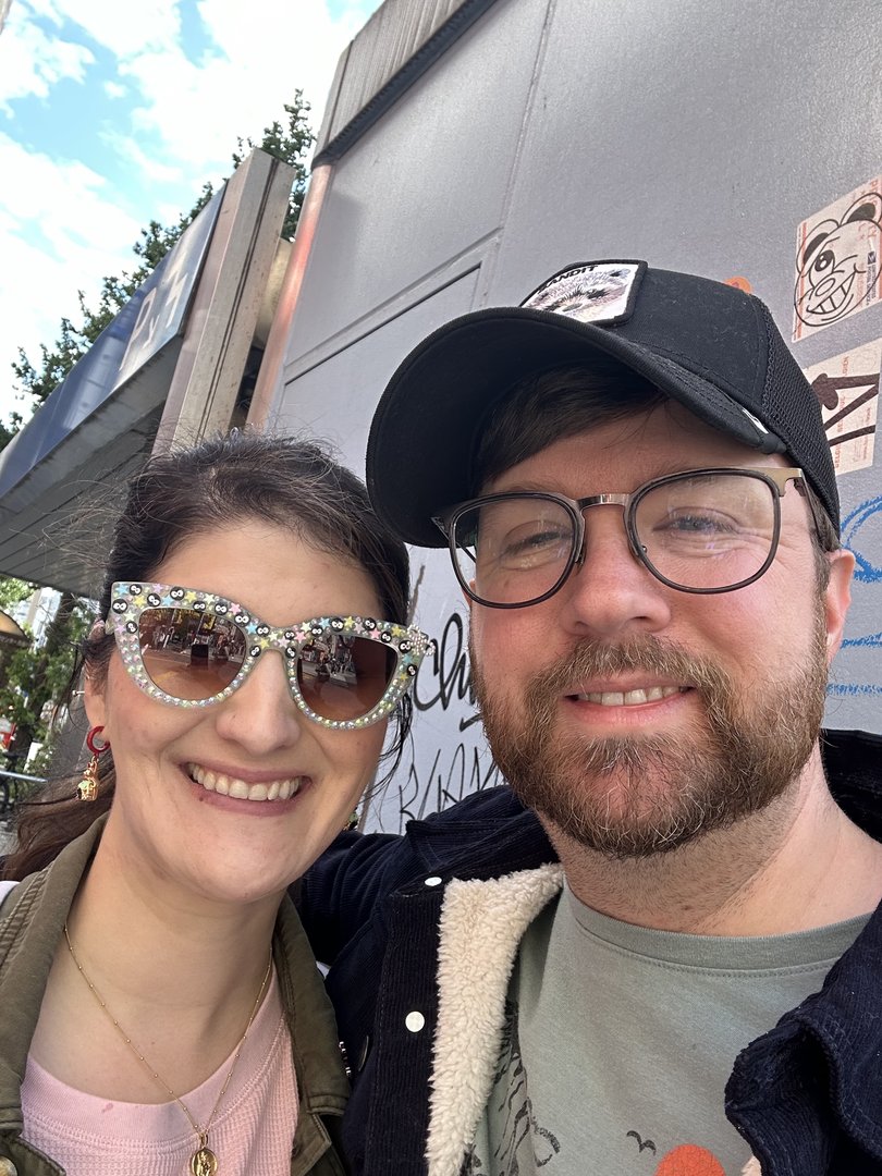 dan and christina taking a quick selfie near the CHAOS of shinjuku station - those bedazzled sunglasses are pure tokyo energy