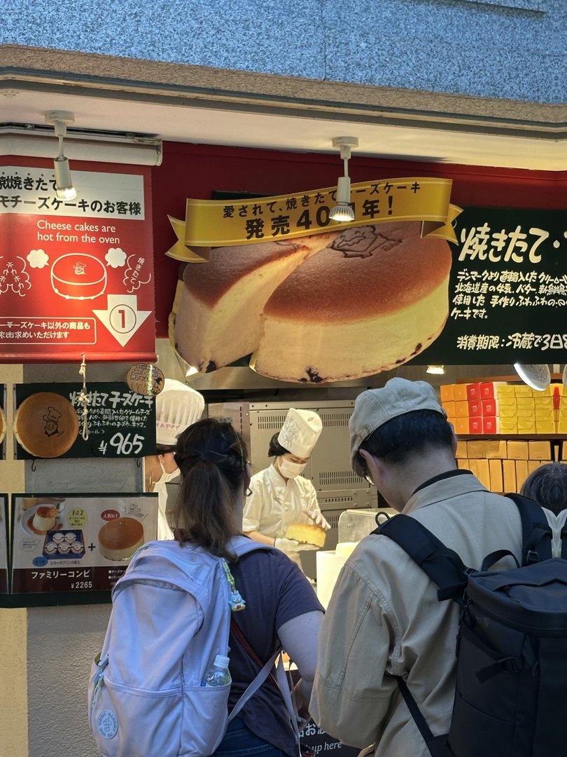 christina and dan waiting in line at the FAMOUS rikuro ojisan cheesecake shop in osaka's namba district - this fluffy japanese cheesecake has been around for 40 years and yes, it was worth the wait