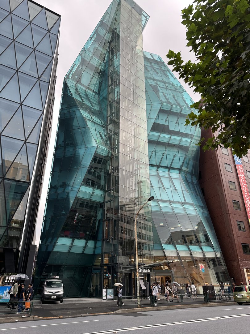 stumbled across this WILD glass building while wandering through shibuya - looks like it's melting right into the street