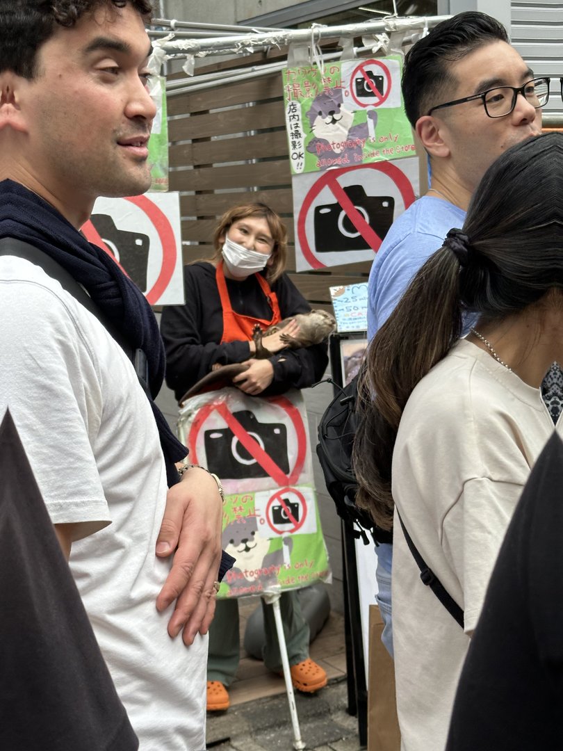 chuck and ashley waiting in line at what looks like a harajuku animal cafe, with signs everywhere telling us NOT to take photos (oops)