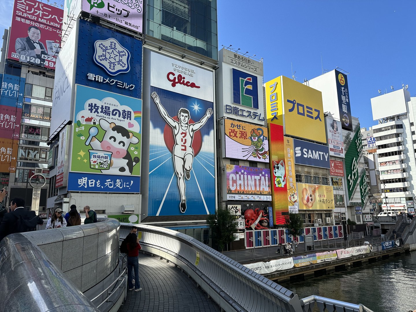 morning walk along the dotonbori canal - dan caught the iconic glico running man sign that's been here since 1935