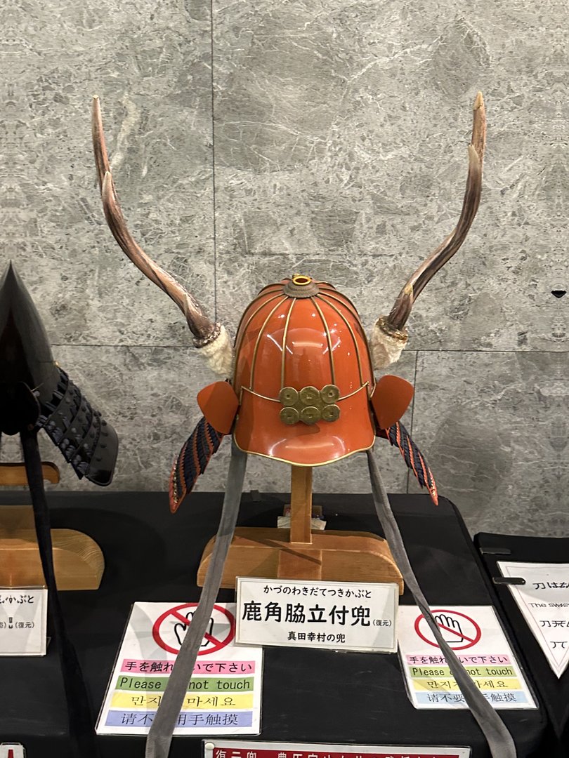 checking out this wild samurai helmet with deer antlers at osaka castle museum - dan's inner history nerd is LIVING for this stuff