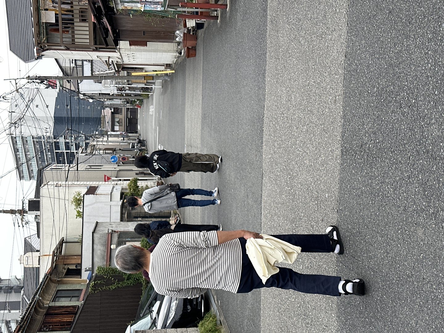 wandering through a quiet residential street in osaka, where even the power lines have their own aesthetic vibe