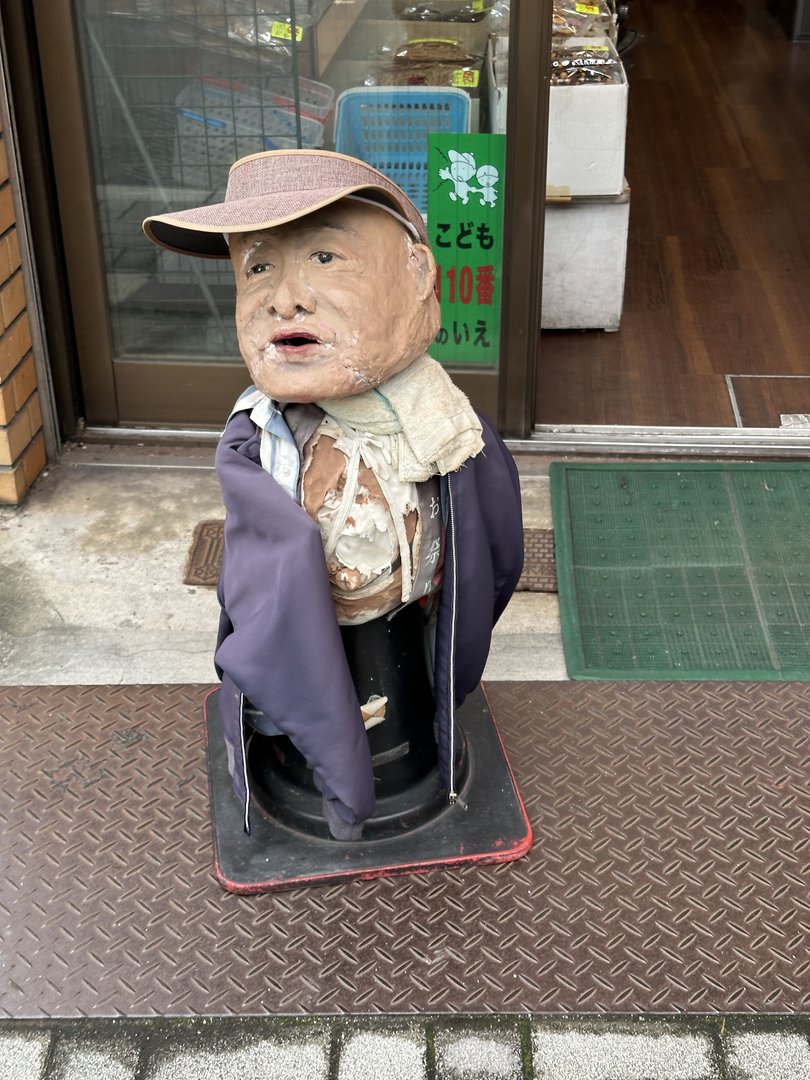 this weathered tanuki statue outside a shop in kyoto's nishijin district has definitely seen better days