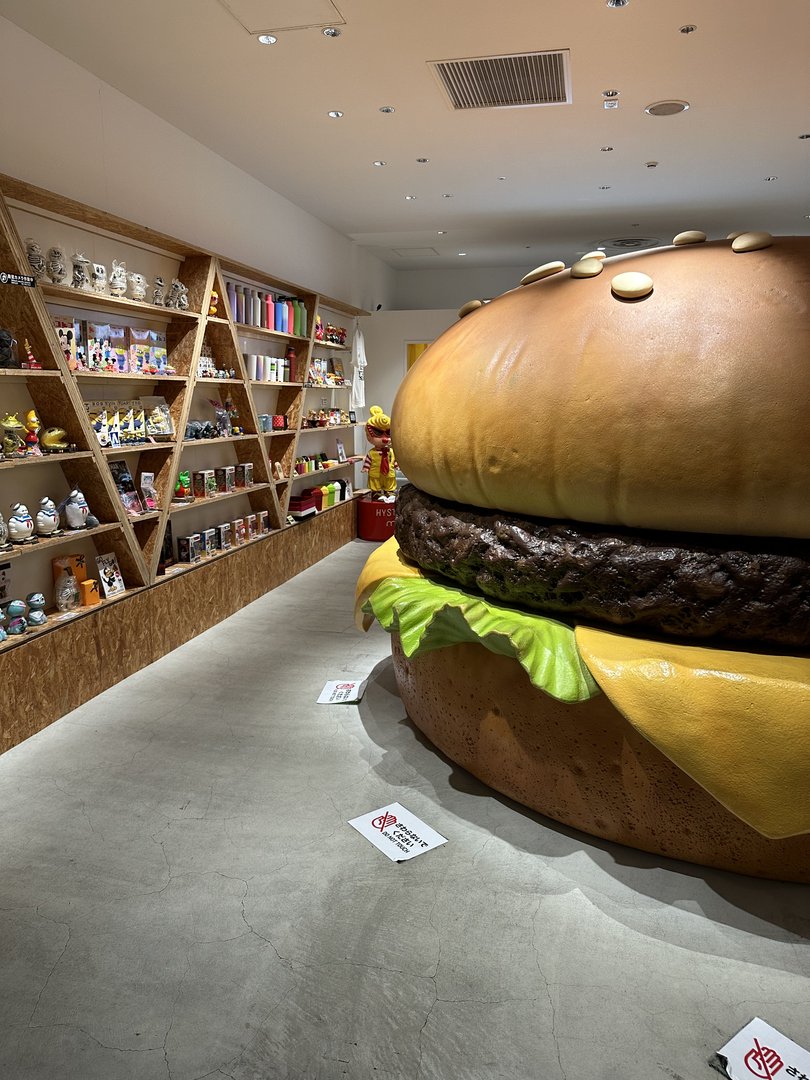 stumbled into this WILD burger-themed shop near dotonbori with shelves full of anime figures and a massive hamburger display. japan's obsession with pop culture never disappoints