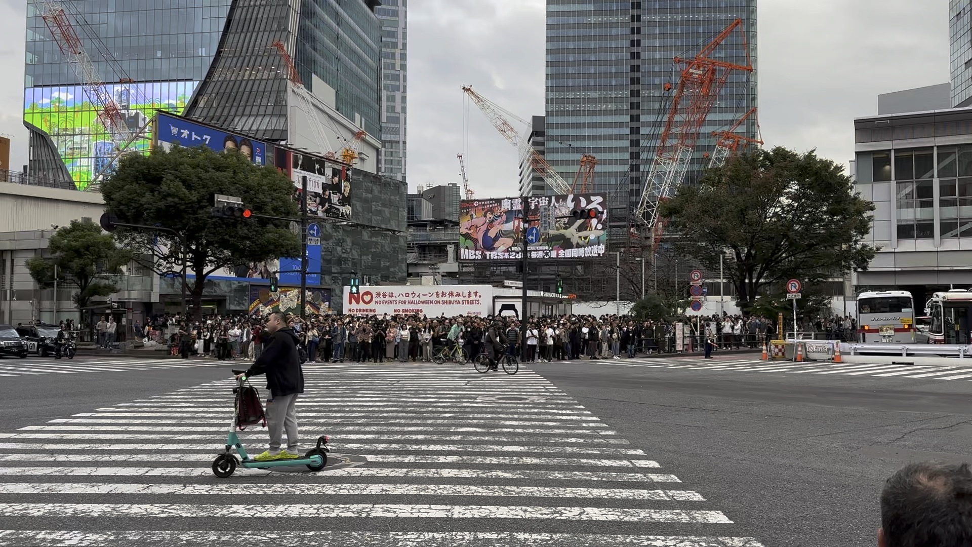 massive crowd gathered at shibuya crossing despite the 'no halloween' signs. tokyo really doesn't mess around with crowd control